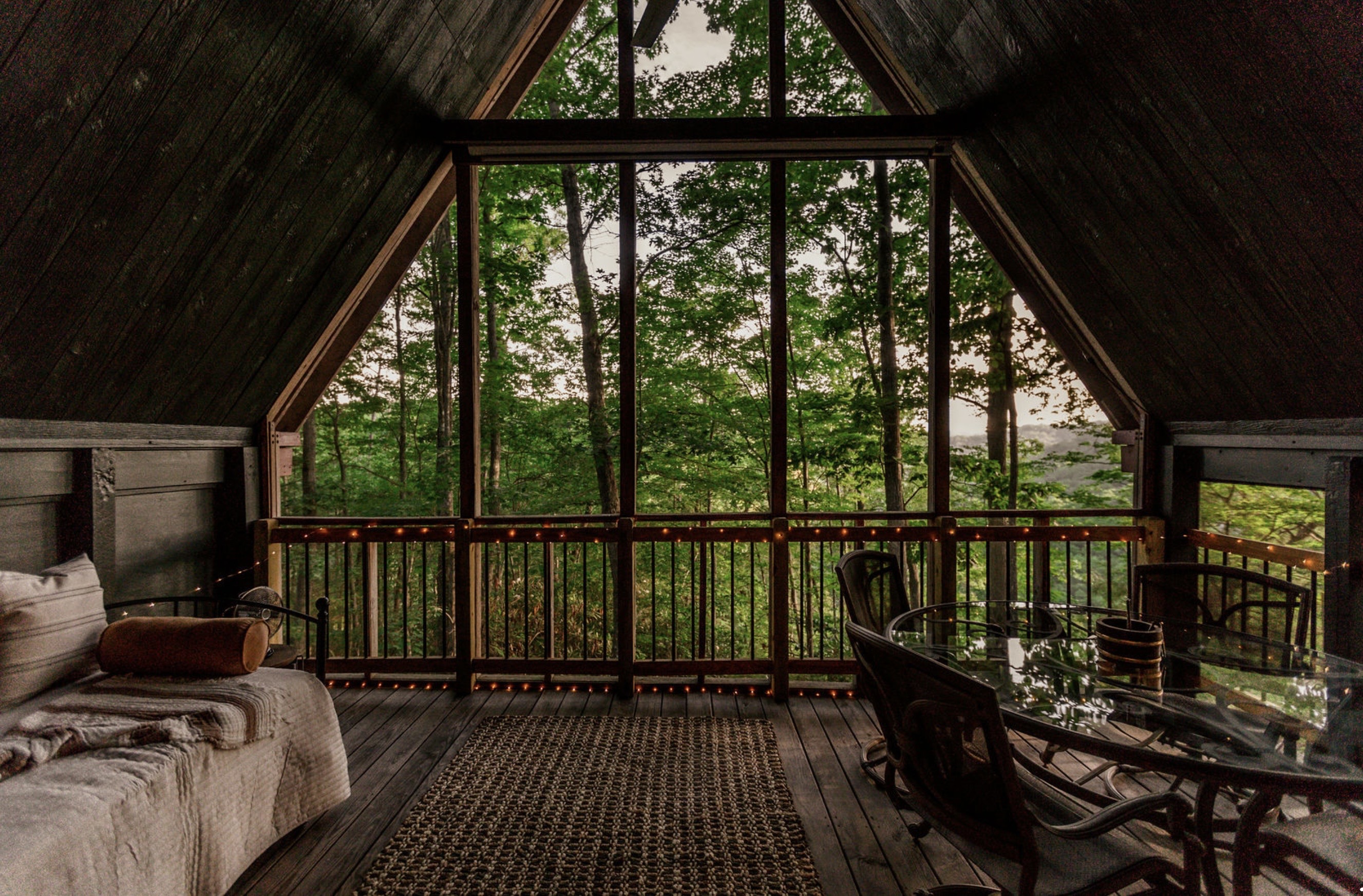 Canyon Ridge Retreats A-frame window view from screened porch showing lush forest canopy