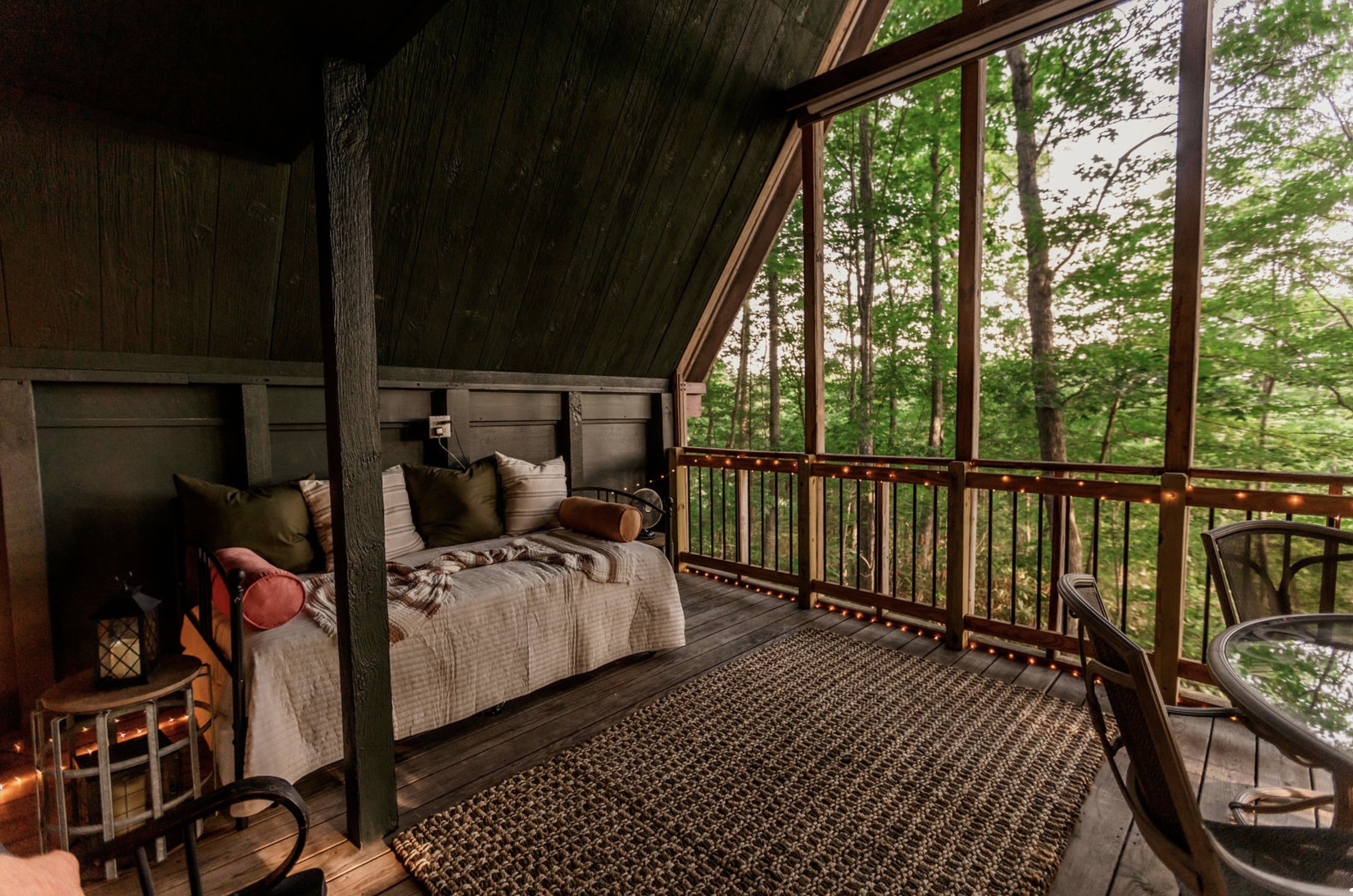 Canyon Ridge Retreats screened porch daybed with A-frame forest view and string lights